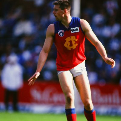 Brett Cook of Fitzroy looks for passing options during the 1995 round 22 AFL match between North Melbourne and Fitzroy.